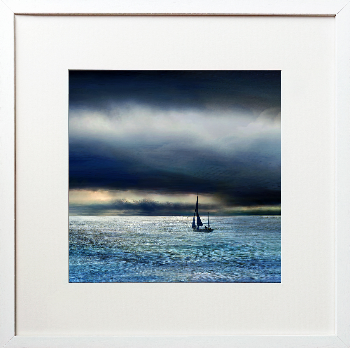 After The Storm is an atmospheric coastal framed fine art print of a sailing boat sailing towards the horizon after a storm at West Bay in Dorset